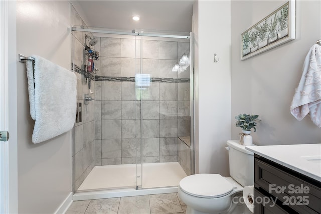 bathroom with vanity, recessed lighting, a stall shower, and toilet