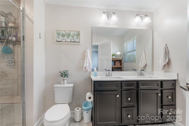 bathroom with double vanity, toilet, a sink, and a stall shower