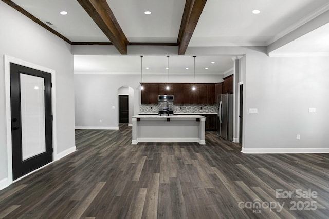 2694 Woodcrest Dr SW, Concord, NC 28027 - kitchen with arched walkways, tasteful backsplash, light countertops, open floor plan, and stainless steel appliances