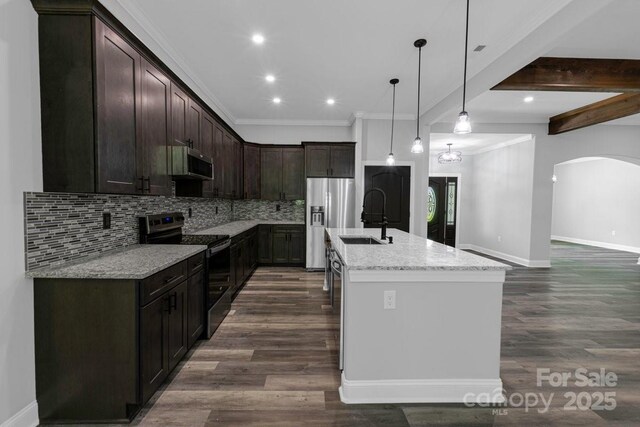 2694 Woodcrest Dr SW, Concord, NC 28027 - kitchen featuring dark brown cabinetry, a sink, stainless steel appliances, baseboards, and tasteful backsplash