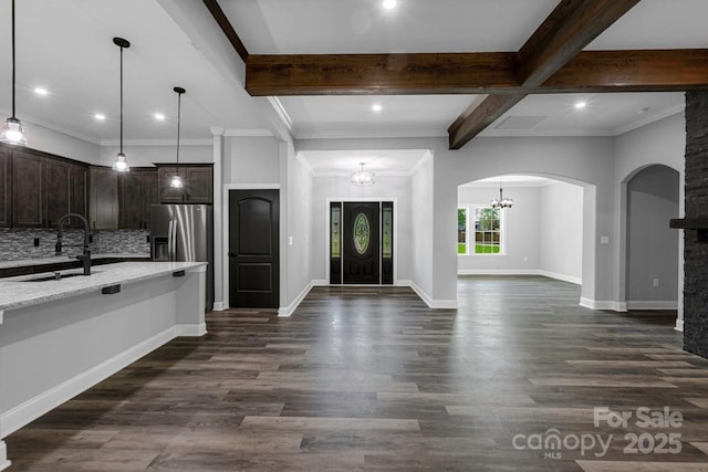 2694 Woodcrest Dr SW, Concord, NC 28027 - kitchen featuring dark brown cabinetry, stainless steel fridge, a sink, beam ceiling, and open floor plan