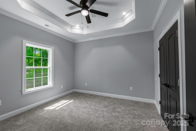 2694 Woodcrest Dr SW, Concord, NC 28027 - spare room with visible vents, crown molding, a ceiling fan, a tray ceiling, and carpet flooring