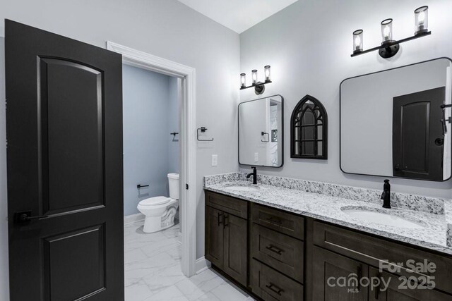 2694 Woodcrest Dr SW, Concord, NC 28027 - full bathroom with double vanity, toilet, a sink, and marble finish floor