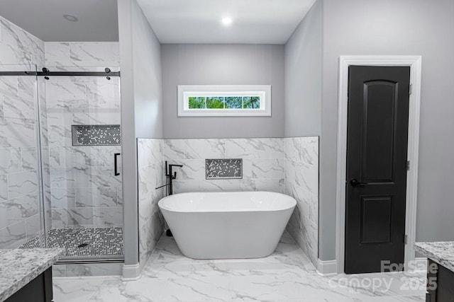 2694 Woodcrest Dr SW, Concord, NC 28027 - bathroom featuring a freestanding bath, wainscoting, vanity, a marble finish shower, and marble finish floor