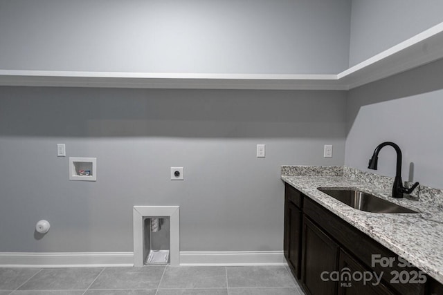 2694 Woodcrest Dr SW, Concord, NC 28027 - laundry room with baseboards, light tile patterned floors, washer hookup, and a sink