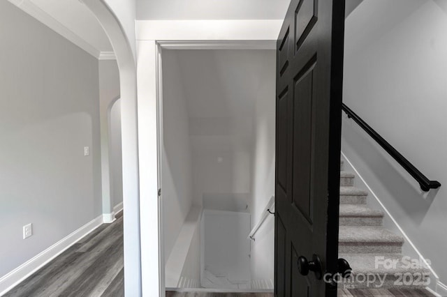 2694 Woodcrest Dr SW, Concord, NC 28027 - stairway with arched walkways, baseboards, and wood finished floors