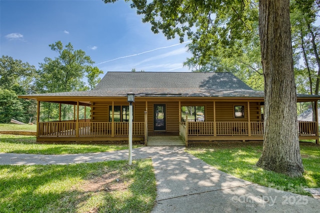 993 Jackson Rd, Fort Lawn, SC 29714 - view of front of house with covered porch, roof with shingles, log siding, and a front lawn