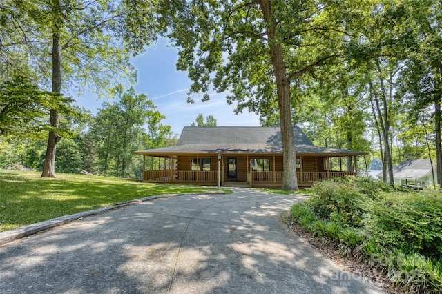 993 Jackson Rd, Fort Lawn, SC 29714 - view of front of home featuring a shingled roof, a front yard, a porch, driveway, and log exterior