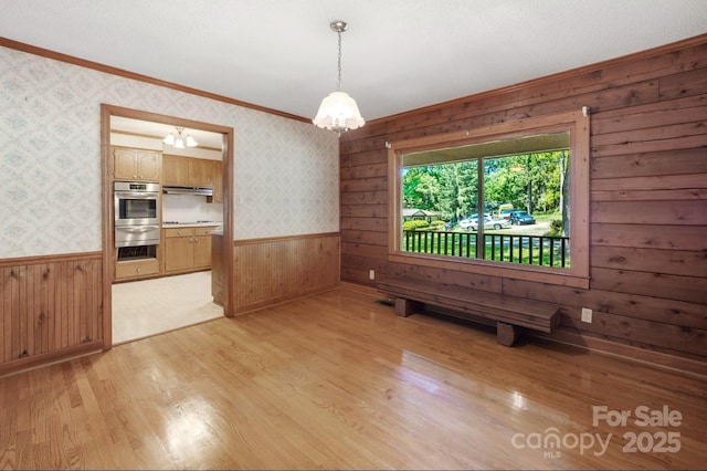 993 Jackson Rd, Fort Lawn, SC 29714 - unfurnished dining area with ornamental molding, wooden walls, a wainscoted wall, and light wood-style floors