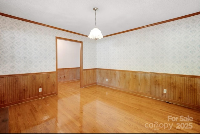 993 Jackson Rd, Fort Lawn, SC 29714 - spare room featuring wood walls, wood finished floors, wainscoting, and ornamental molding