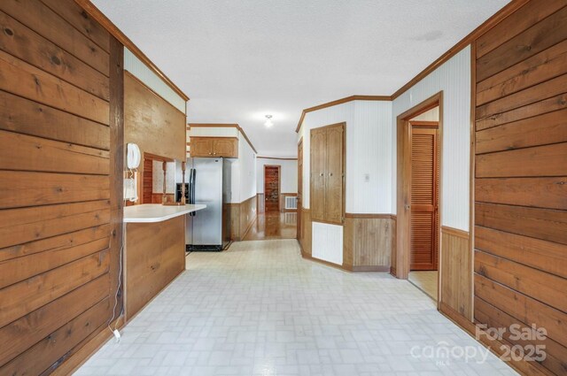 993 Jackson Rd, Fort Lawn, SC 29714 - hall with a wainscoted wall, visible vents, crown molding, wooden walls, and brick patterned floor