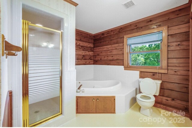 993 Jackson Rd, Fort Lawn, SC 29714 - full bath featuring toilet, visible vents, a shower stall, wood walls, and a garden tub