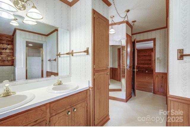 993 Jackson Rd, Fort Lawn, SC 29714 - bathroom featuring a sink, crown molding, and wallpapered walls