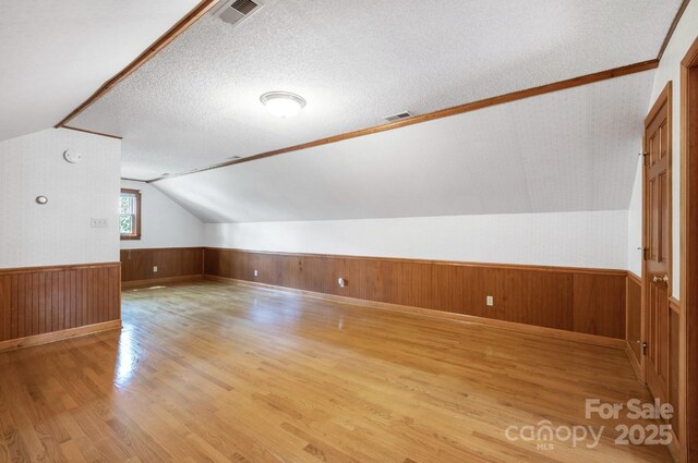 993 Jackson Rd, Fort Lawn, SC 29714 - bonus room with wainscoting, light wood finished floors, lofted ceiling, and visible vents