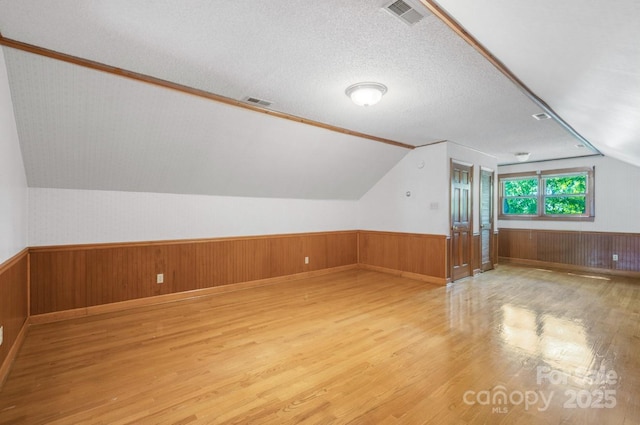 993 Jackson Rd, Fort Lawn, SC 29714 - bonus room featuring wainscoting, vaulted ceiling, visible vents, and wood finished floors