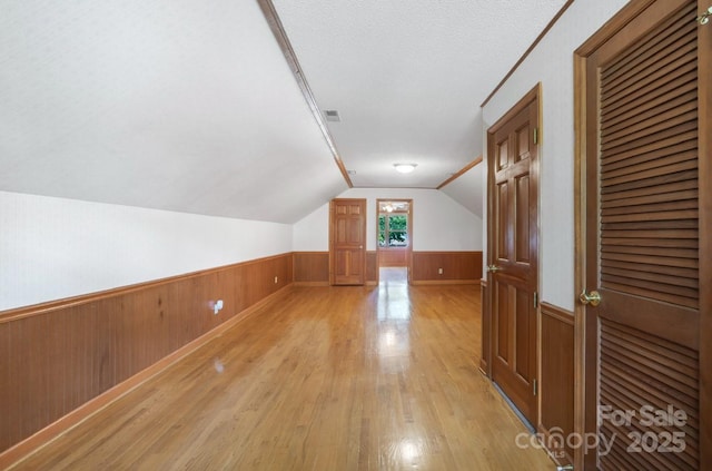 993 Jackson Rd, Fort Lawn, SC 29714 - bonus room with visible vents, wainscoting, light wood-style floors, wooden walls, and lofted ceiling