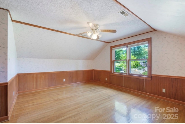 993 Jackson Rd, Fort Lawn, SC 29714 - bonus room with a wainscoted wall, light wood-style floors, visible vents, and lofted ceiling