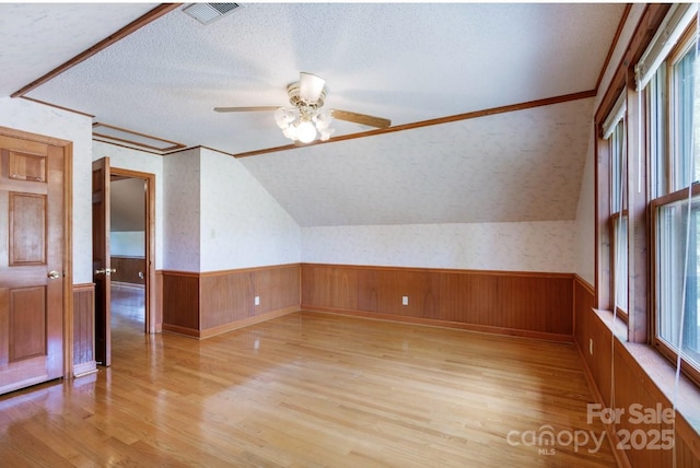 993 Jackson Rd, Fort Lawn, SC 29714 - bonus room featuring a textured ceiling, light wood finished floors, ceiling fan, visible vents, and a wainscoted wall