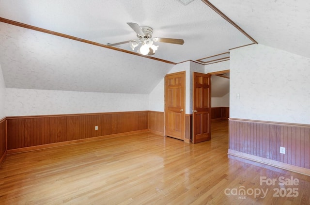 993 Jackson Rd, Fort Lawn, SC 29714 - additional living space featuring light wood finished floors, a wainscoted wall, a ceiling fan, and lofted ceiling