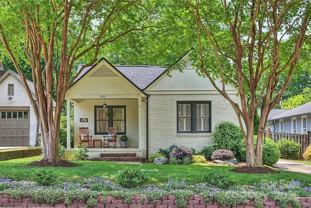 2015 Club Rd, Charlotte, NC 28205 - view of front of home featuring covered porch, brick siding, fence, and roof with shingles