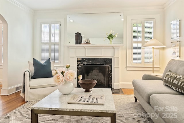 2015 Club Rd, Charlotte, NC 28205 - living area with arched walkways, wood finished floors, a premium fireplace, and ornamental molding
