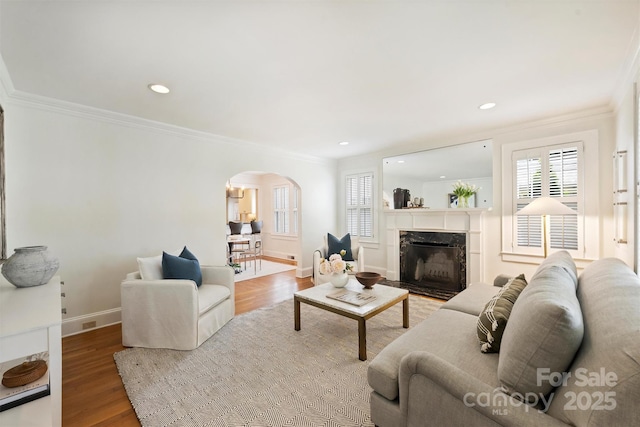 2015 Club Rd, Charlotte, NC 28205 - living area featuring arched walkways, baseboards, ornamental molding, and a healthy amount of sunlight