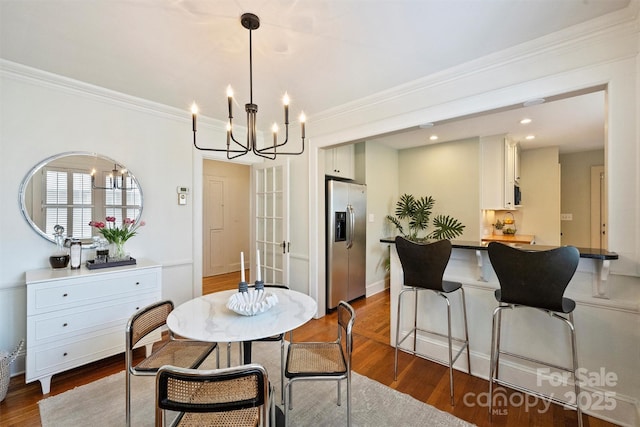 2015 Club Rd, Charlotte, NC 28205 - dining area with an inviting chandelier, ornamental molding, and dark wood-style flooring