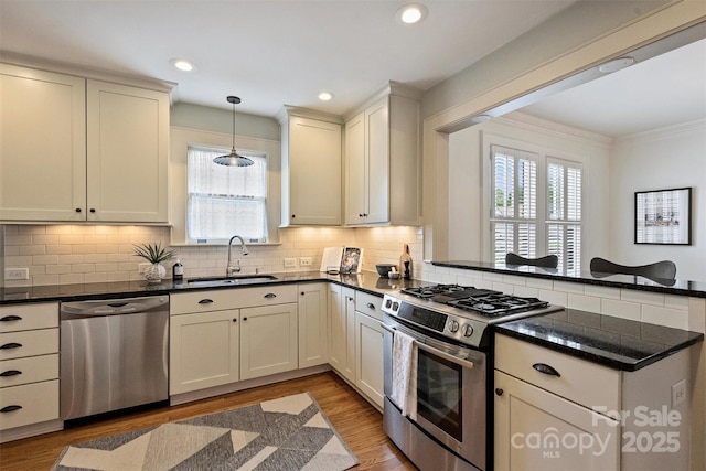 2015 Club Rd, Charlotte, NC 28205 - kitchen featuring plenty of natural light, a sink, a peninsula, and stainless steel appliances