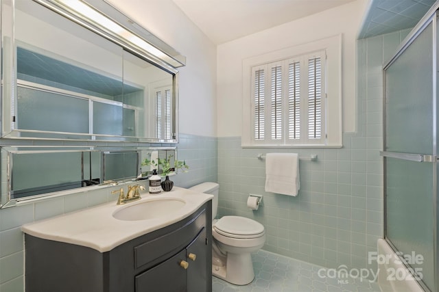 2015 Club Rd, Charlotte, NC 28205 - bathroom with tile walls, vanity, a wainscoted wall, toilet, and a shower with door