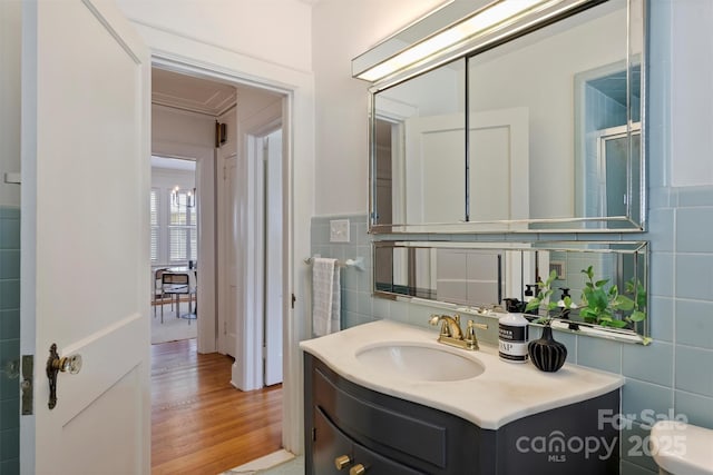 2015 Club Rd, Charlotte, NC 28205 - bathroom featuring vanity, wood finished floors, and tile walls