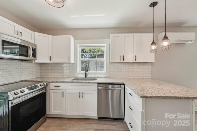 814 Marve St, Gastonia, NC 28052 - kitchen with a sink, white cabinets, appliances with stainless steel finishes, and a peninsula