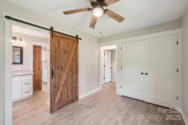 814 Marve St, Gastonia, NC 28052 - unfurnished bedroom with baseboards, light wood-style flooring, a closet, and a barn door