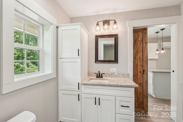 814 Marve St, Gastonia, NC 28052 - half bathroom with toilet, an inviting chandelier, wood finished floors, and vanity