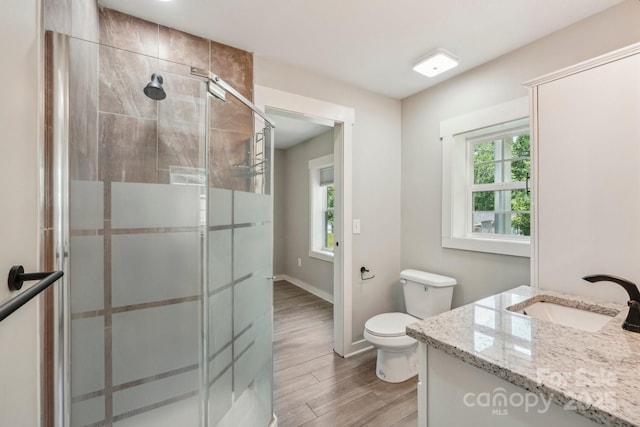 814 Marve St, Gastonia, NC 28052 - bathroom with vanity, wood finished floors, toilet, baseboards, and a shower stall