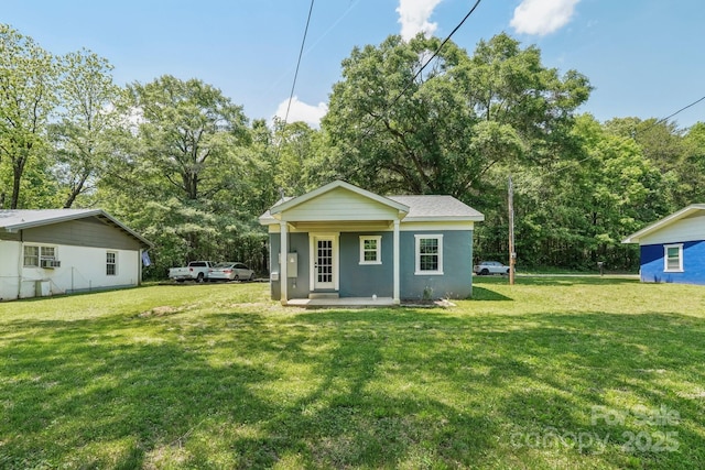 814 Marve St, Gastonia, NC 28052 - back of house with a porch, stucco siding, and a yard
