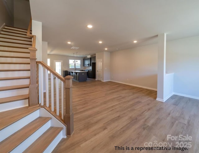stairs featuring recessed lighting, baseboards, and wood finished floors