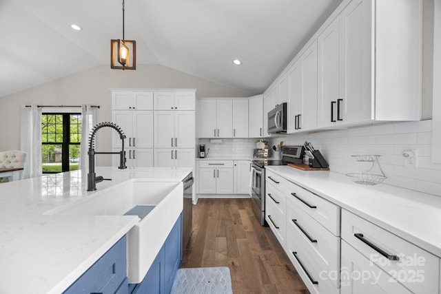 17403 Green Hill Rd, Charlotte, NC 28278 - kitchen featuring appliances with stainless steel finishes, white cabinets, vaulted ceiling, dark wood-style flooring, and tasteful backsplash