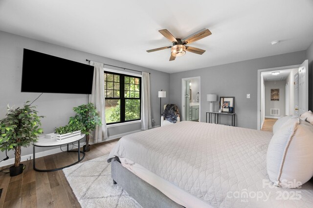 17403 Green Hill Rd, Charlotte, NC 28278 - bedroom featuring attic access, hardwood / wood-style floors, baseboards, ensuite bathroom, and ceiling fan