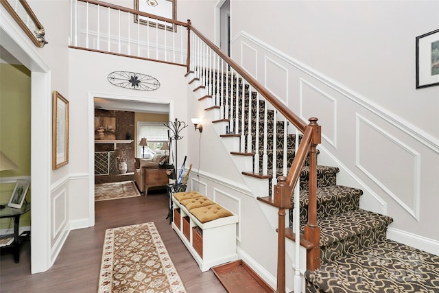 10209 Thomas Payne Cir, Charlotte, NC 28277 - stairway featuring a wainscoted wall, a decorative wall, and wood finished floors