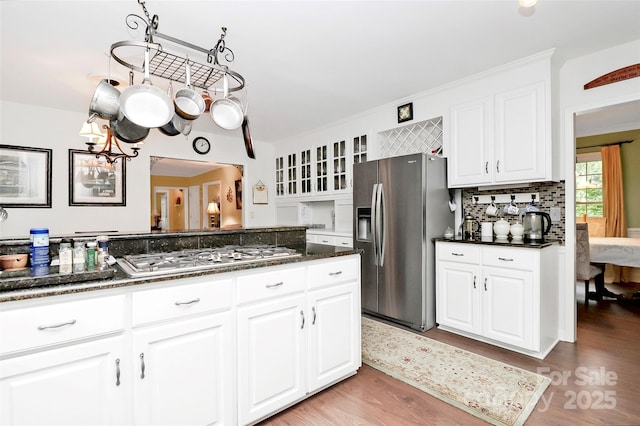 10209 Thomas Payne Cir, Charlotte, NC 28277 - kitchen with light wood-style floors, white cabinetry, appliances with stainless steel finishes, and glass insert cabinets