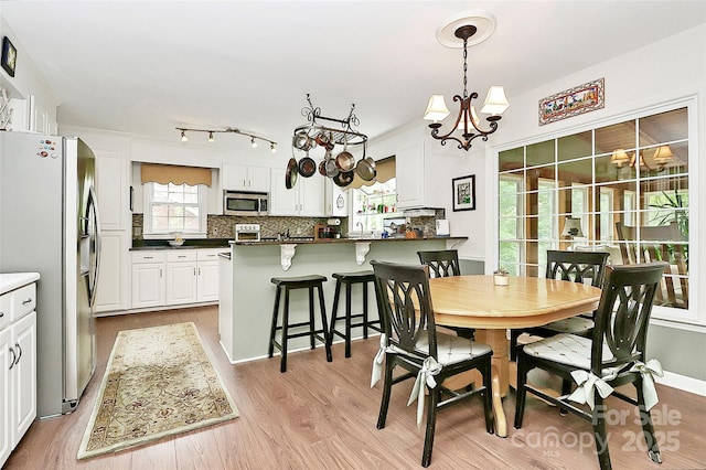 10209 Thomas Payne Cir, Charlotte, NC 28277 - dining room with an inviting chandelier and light wood finished floors