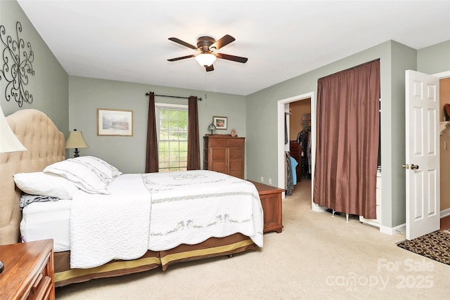 10209 Thomas Payne Cir, Charlotte, NC 28277 - bedroom featuring a closet, baseboards, a walk in closet, light colored carpet, and a ceiling fan