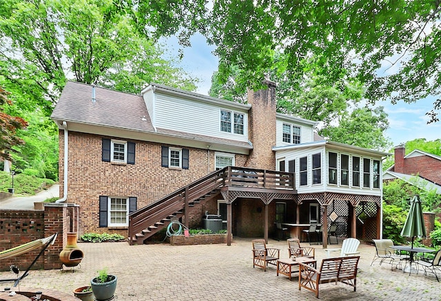 10209 Thomas Payne Cir, Charlotte, NC 28277 - rear view of house with a chimney, stairs, brick siding, a sunroom, and a patio area