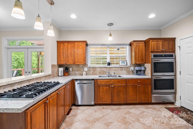kitchen featuring appliances with stainless steel finishes, a warming drawer, a sink, light countertops, and brown cabinetry