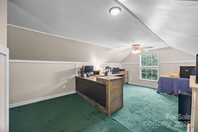 carpeted home office featuring lofted ceiling, baseboards, and a ceiling fan