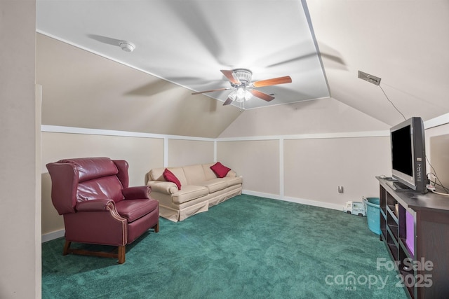 carpeted living area featuring vaulted ceiling and a ceiling fan