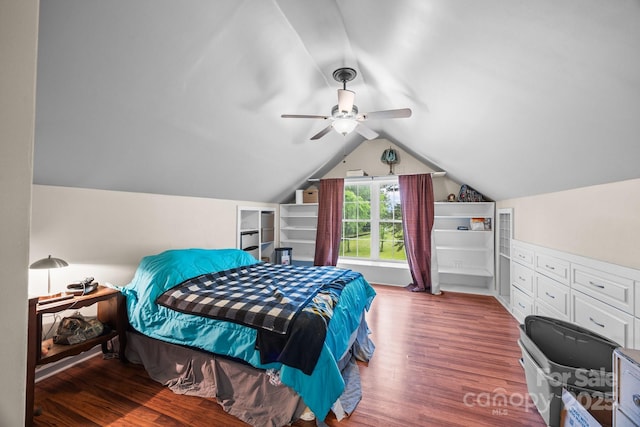 bedroom featuring wood finished floors, vaulted ceiling, and a ceiling fan
