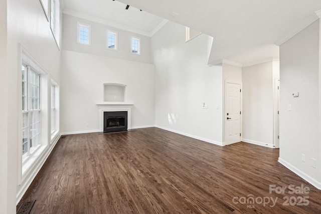 5745 Snapdragon Ln, Huntersville, NC 28078 - unfurnished living room featuring baseboards, dark wood finished floors, ornamental molding, and a fireplace