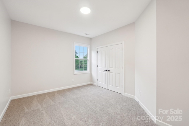 5745 Snapdragon Ln, Huntersville, NC 28078 - unfurnished bedroom featuring carpet floors, baseboards, and visible vents