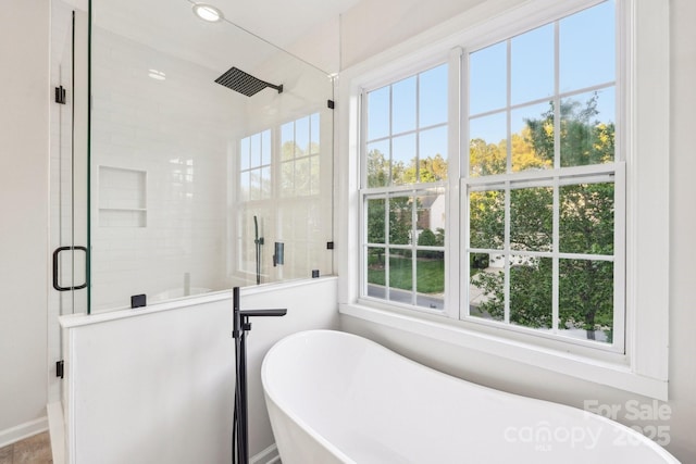 5745 Snapdragon Ln, Huntersville, NC 28078 - bathroom with a freestanding bath, a stall shower, and a healthy amount of sunlight